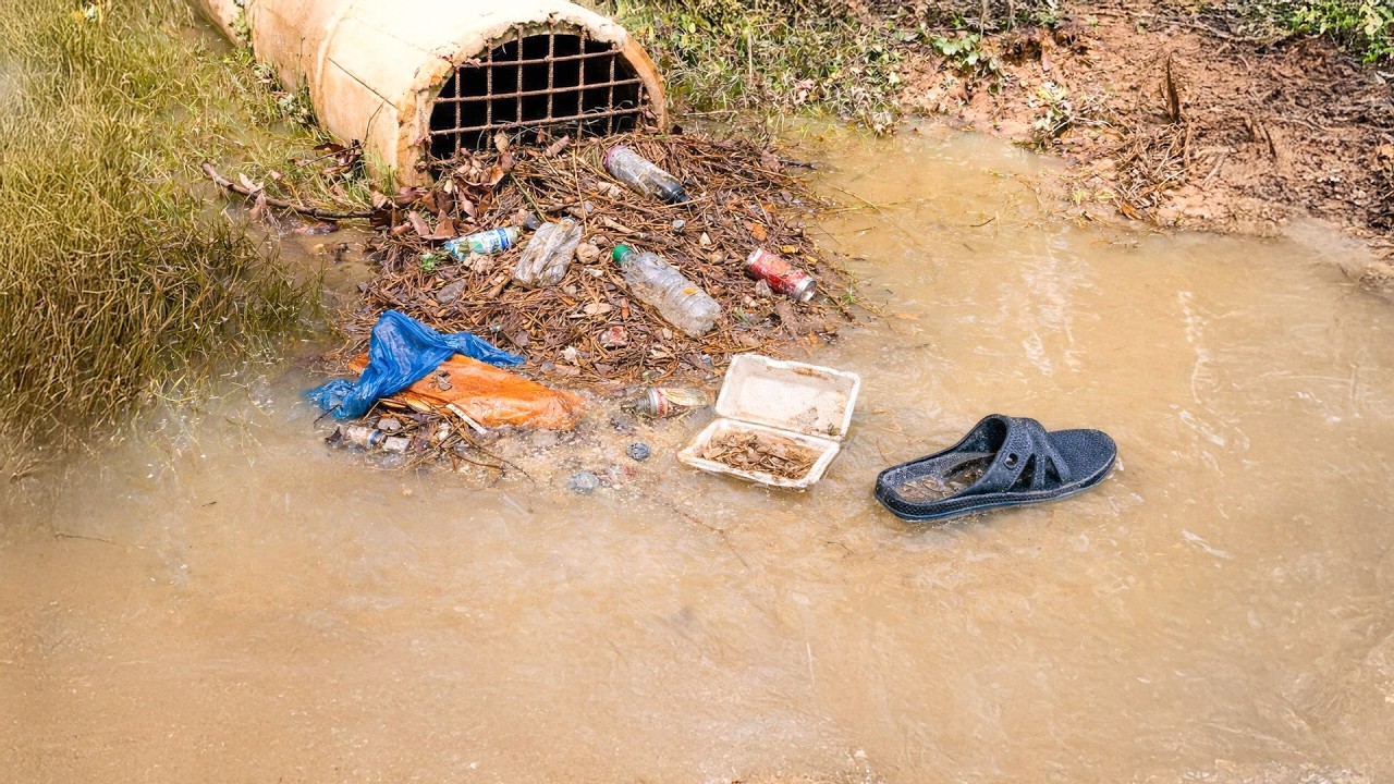 Unclogging a Culvert Packed with Mud and Trash