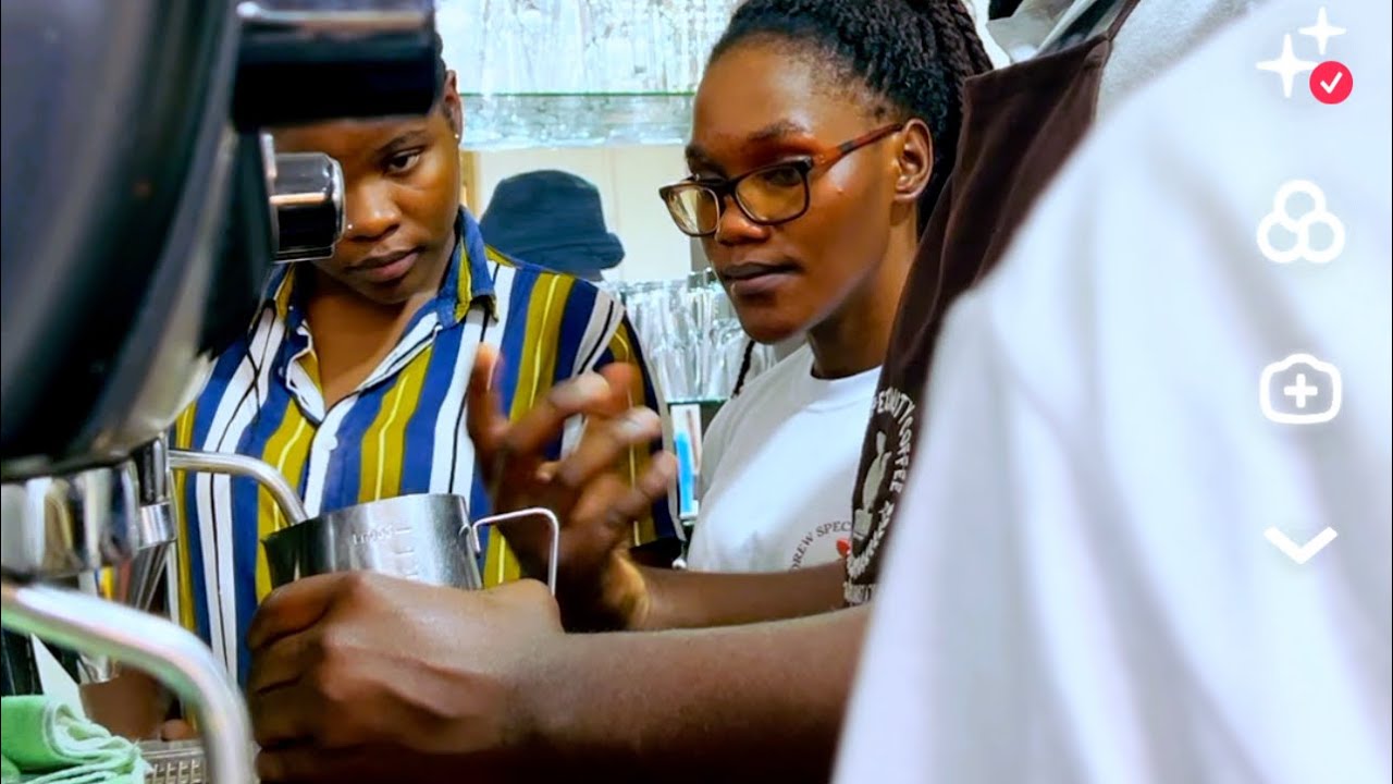 Ugandan locals learn how to steam Milk on modern machine