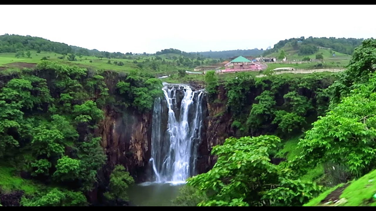 Passing Patalpani waterfalls by meter gauge train -Tourists enjoying the falls...
