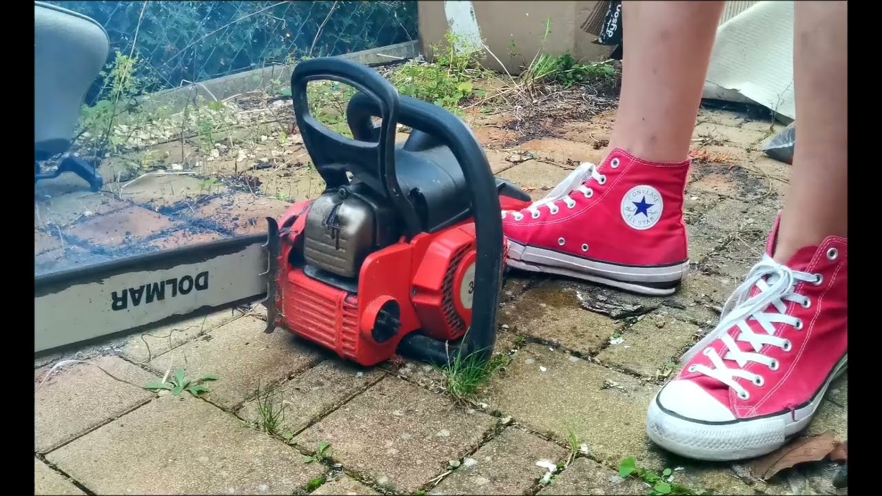 A girl starting and warming up her chainsaw