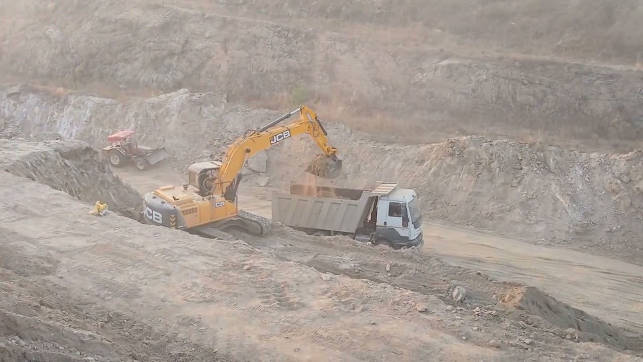 Excavator lover, JCB225LCM cutting and loading work at railway siding 