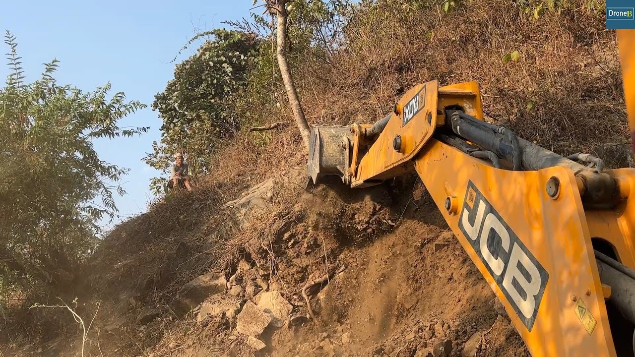 Steep Rocky Mountainside New Road Construction Work with JCB Backhoe