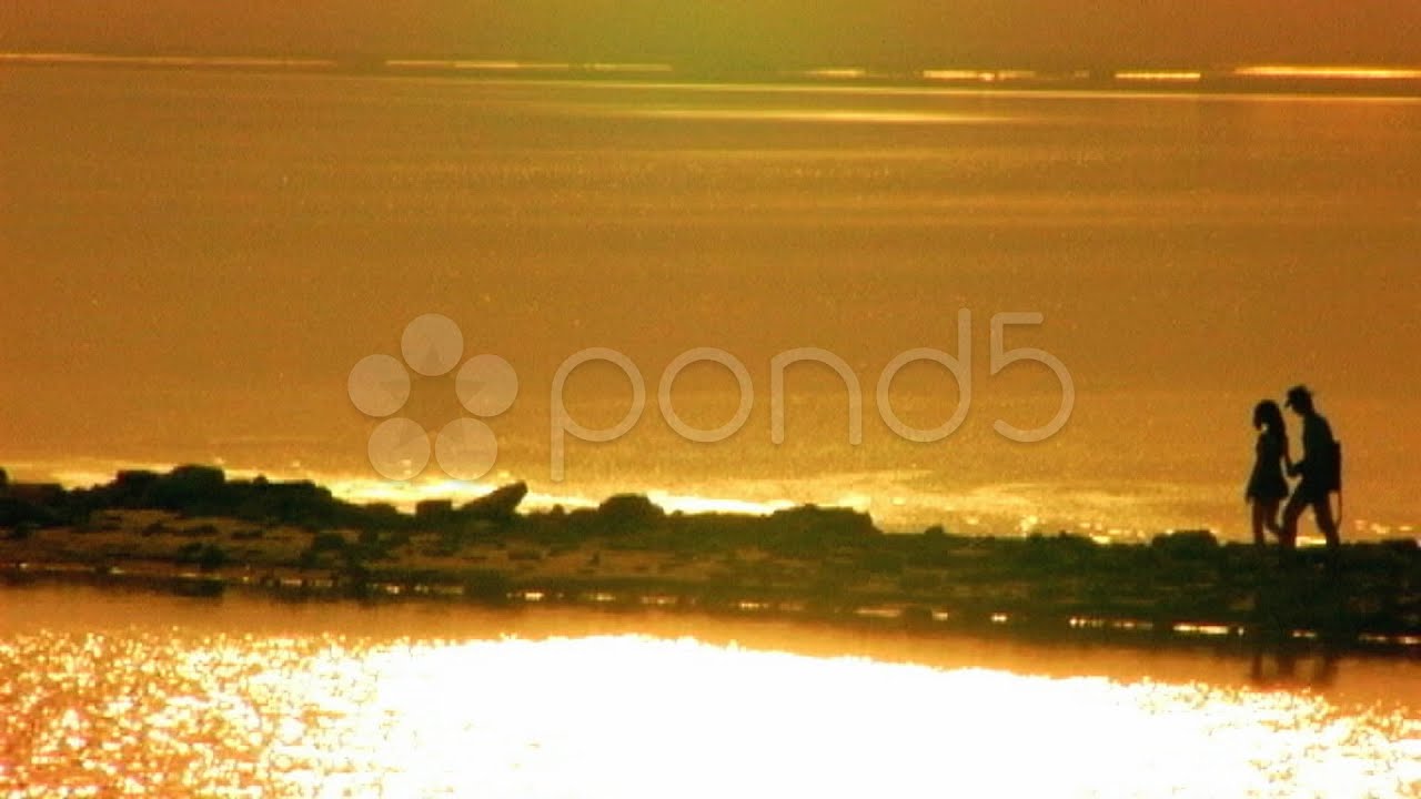 Romantic Couple Walking On Ocean Pier Sunset. Stock Footage