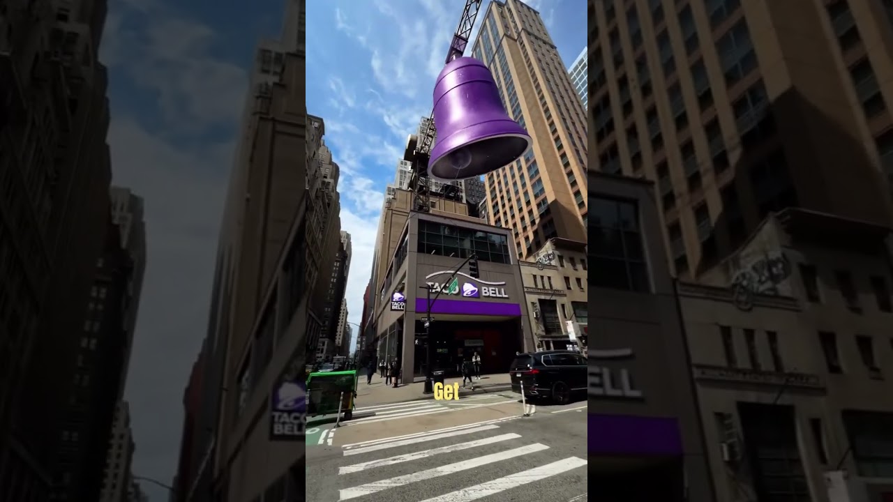 A man rings a giant bell in the middle of city