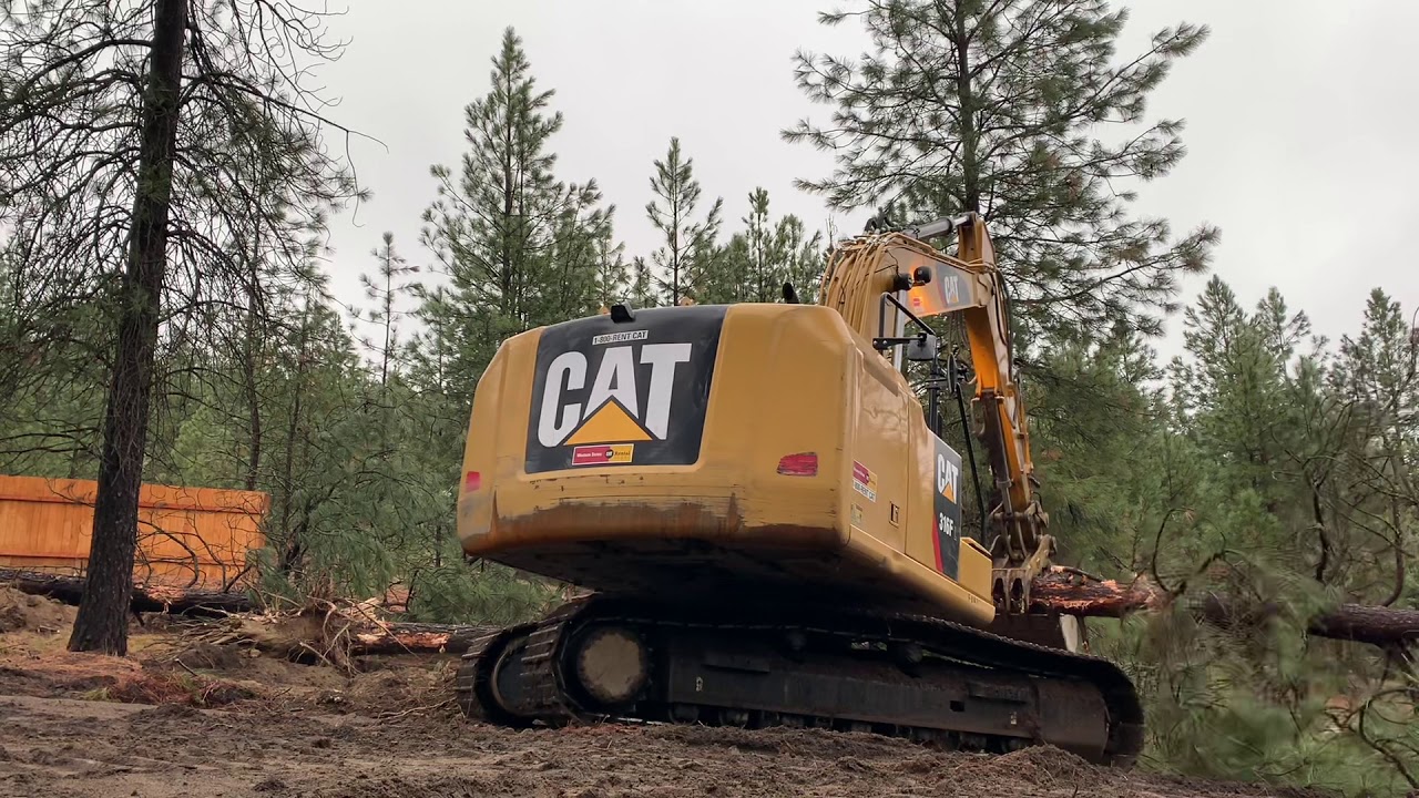 Cat 316 clearing land