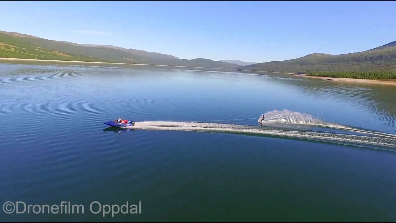 Gjevilvassdalen, Oppdal, Norway - Waterskiing, mountains and beautiful nature - Aerial Drone Video