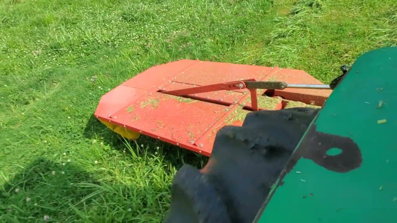 cutting hay with the drum mower and tedding.