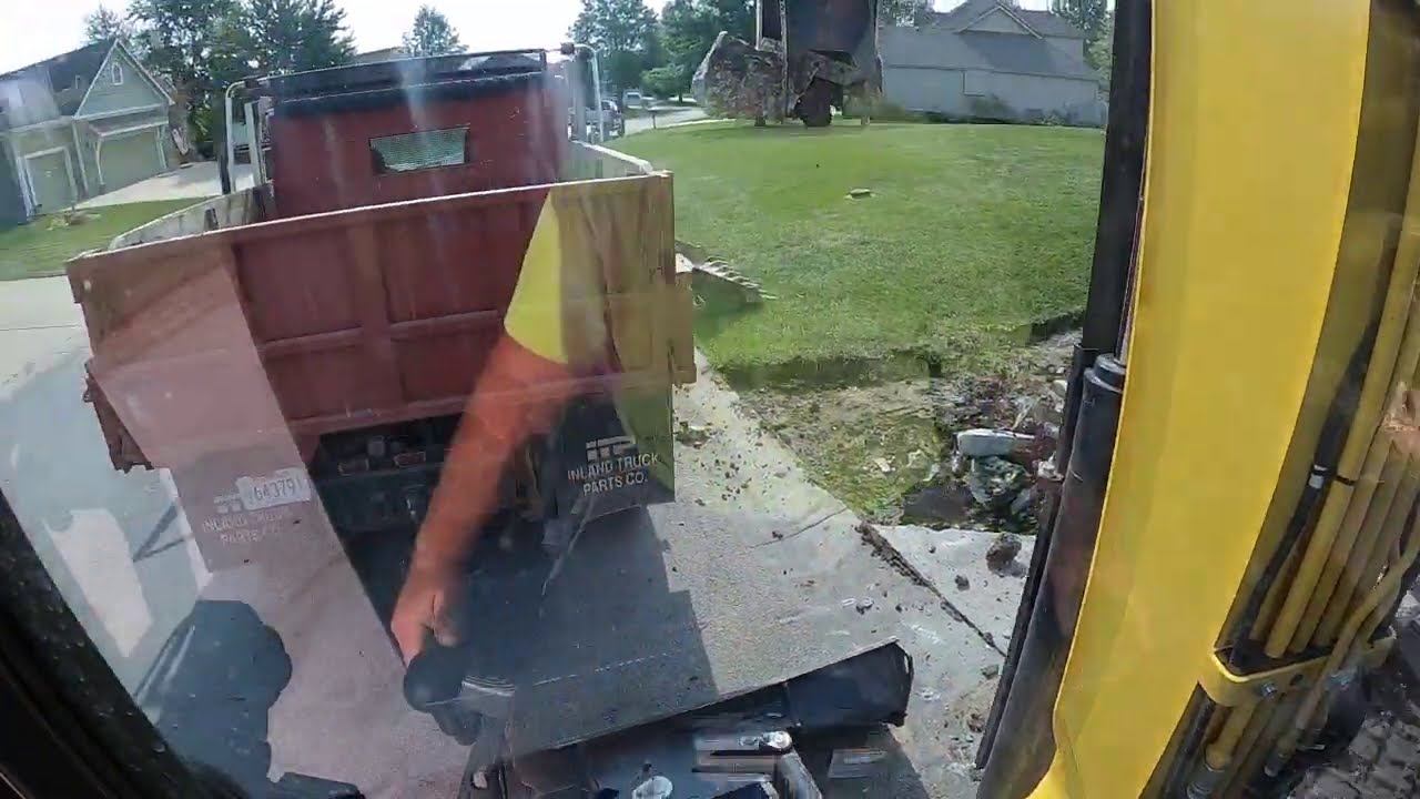 Yanmar VIO50 tearing out a concrete driveway