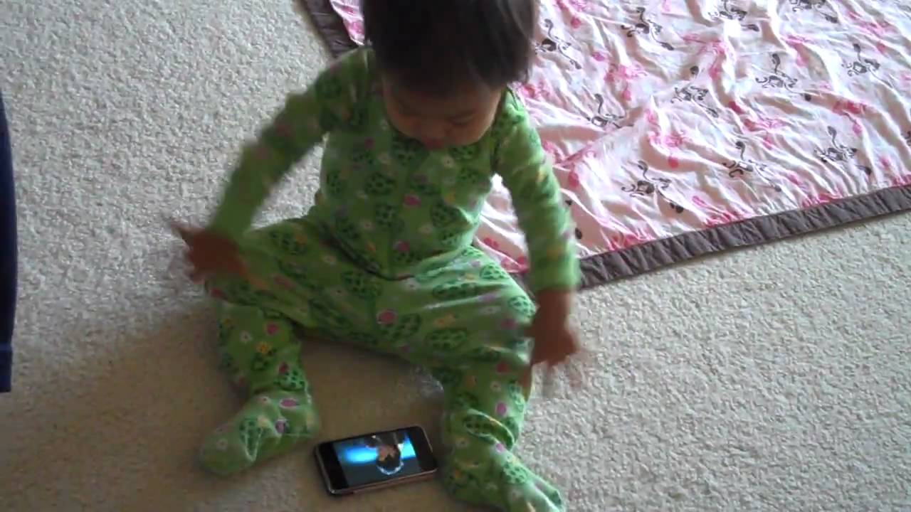 Paisley (15 mos) watching Adam Lambert on iPhone