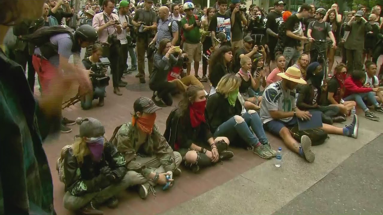 Far-left protesters sit in downtown Portland street
