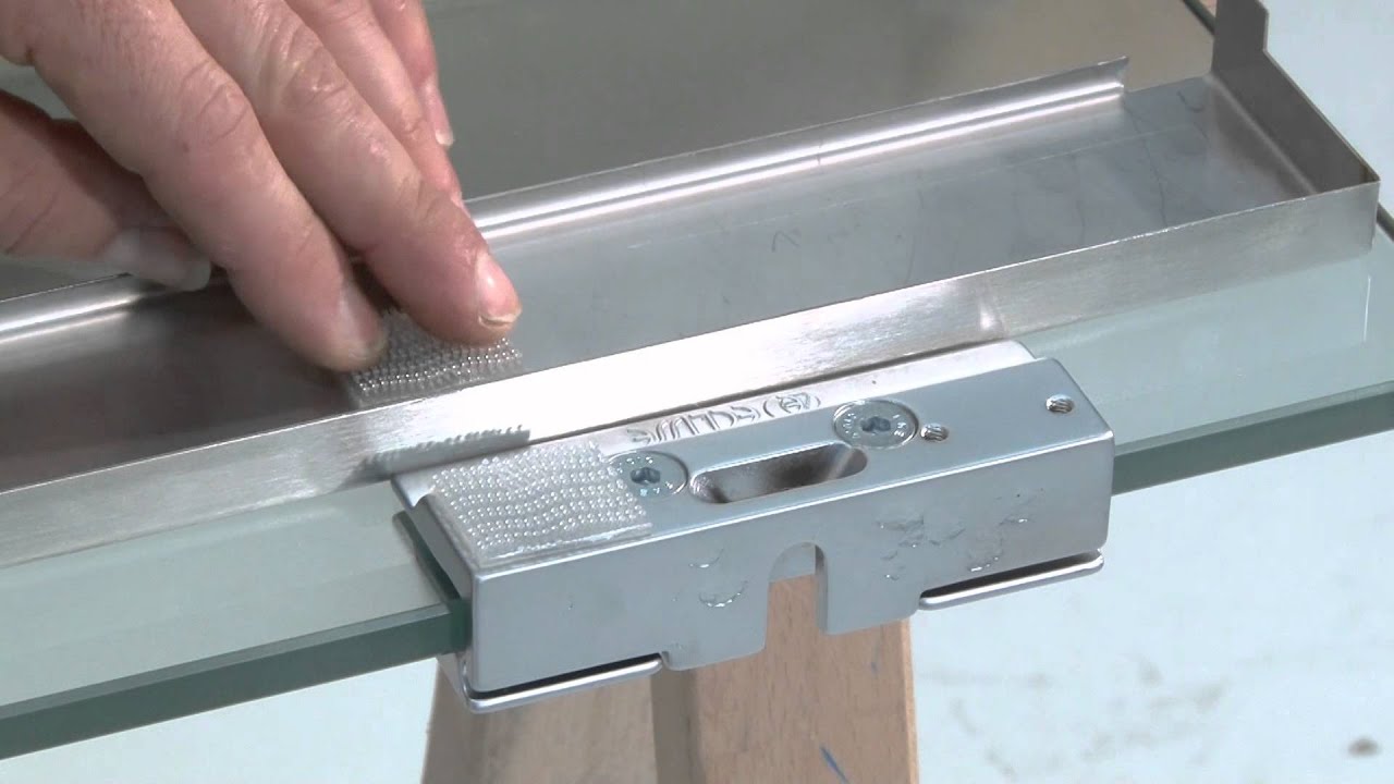 Vitro on 10 mm glass door with brackets installation