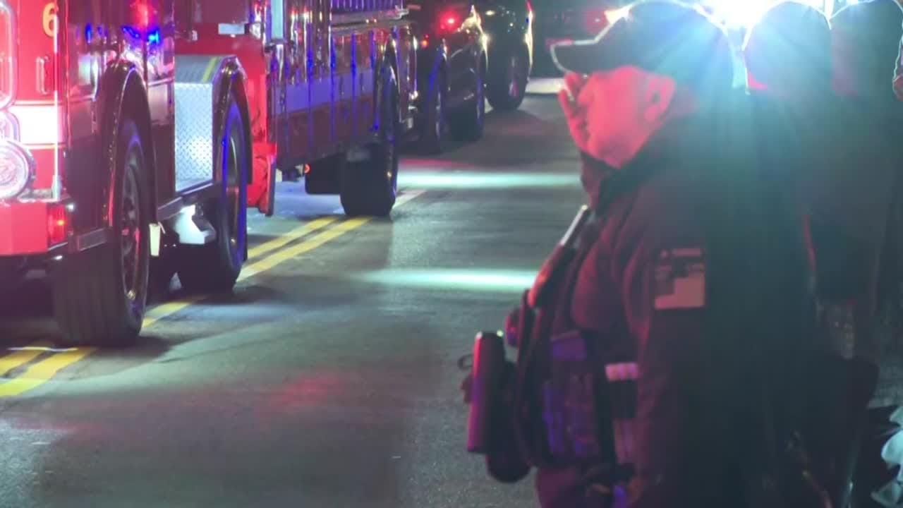 Officers line procession for dignified transfer of National Guard Member killed in shooting