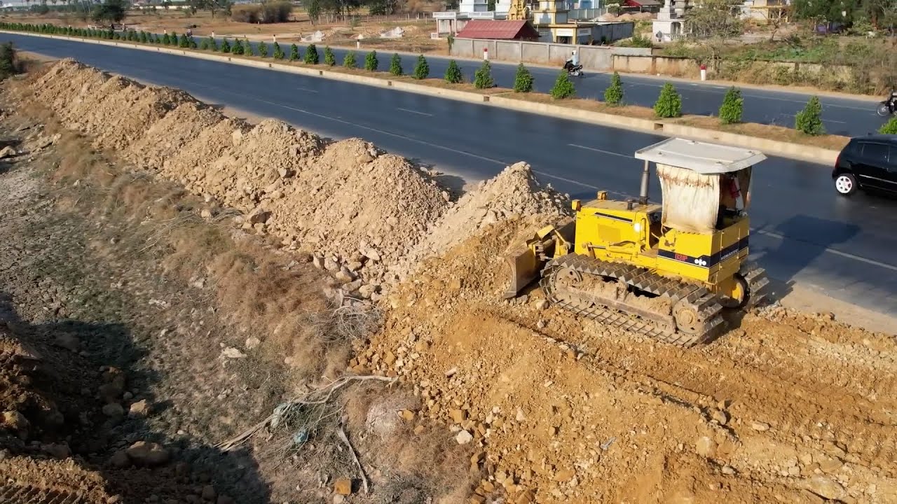 Dozer Komat’su d31p pushing soil fast and 5 ton truck