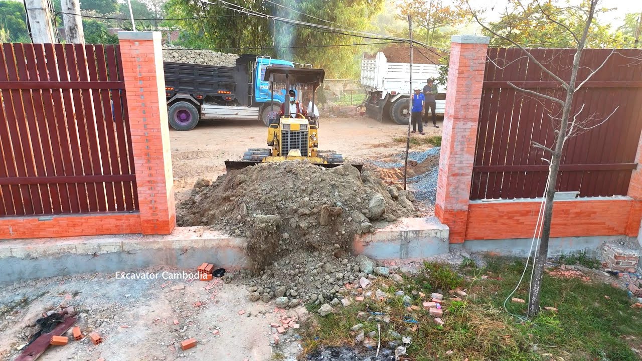 Many 6wheel truck and d20 bulldozer working unloading pushing dirt making  filling In fencev32 x 56M