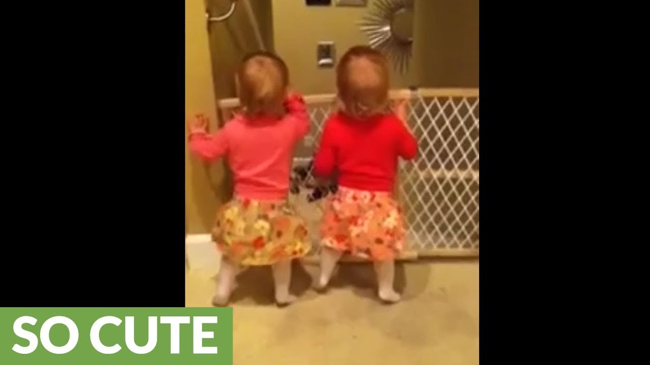 Identical twins thrilled when daddy comes home