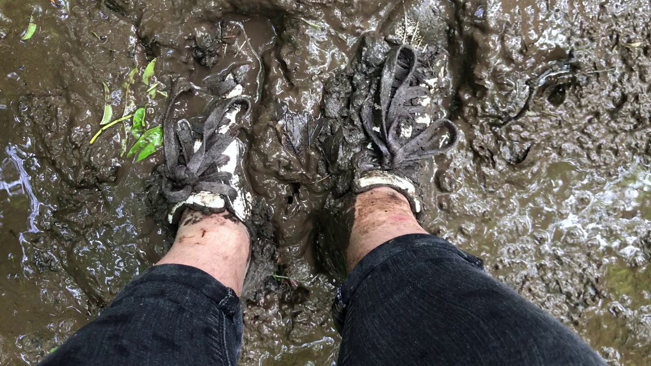walking through mud in Adidas Superstar sneakers, sockless