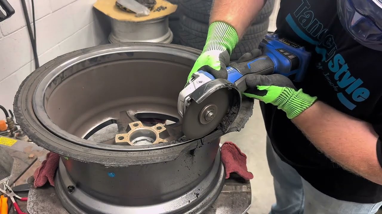 Cutting a tire off the wheel after the sidewall rips.