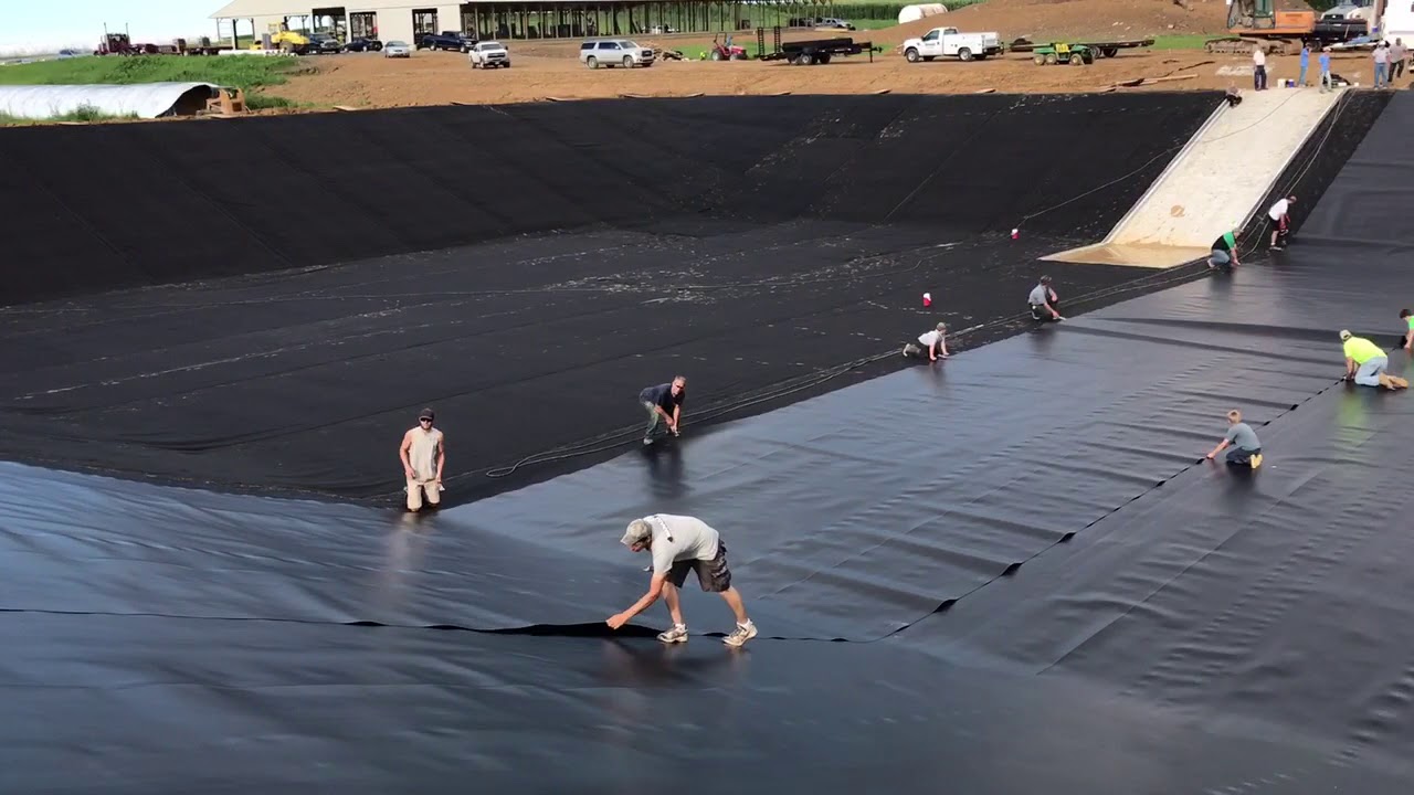 HDPE waste storage Pulling 60 mil HDPE liner PA1