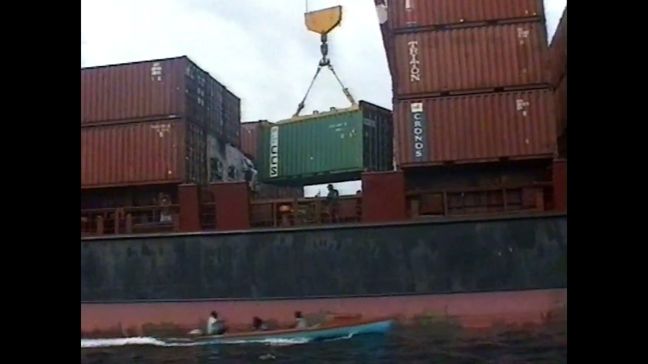 Loading shipping container with an on-ship crane