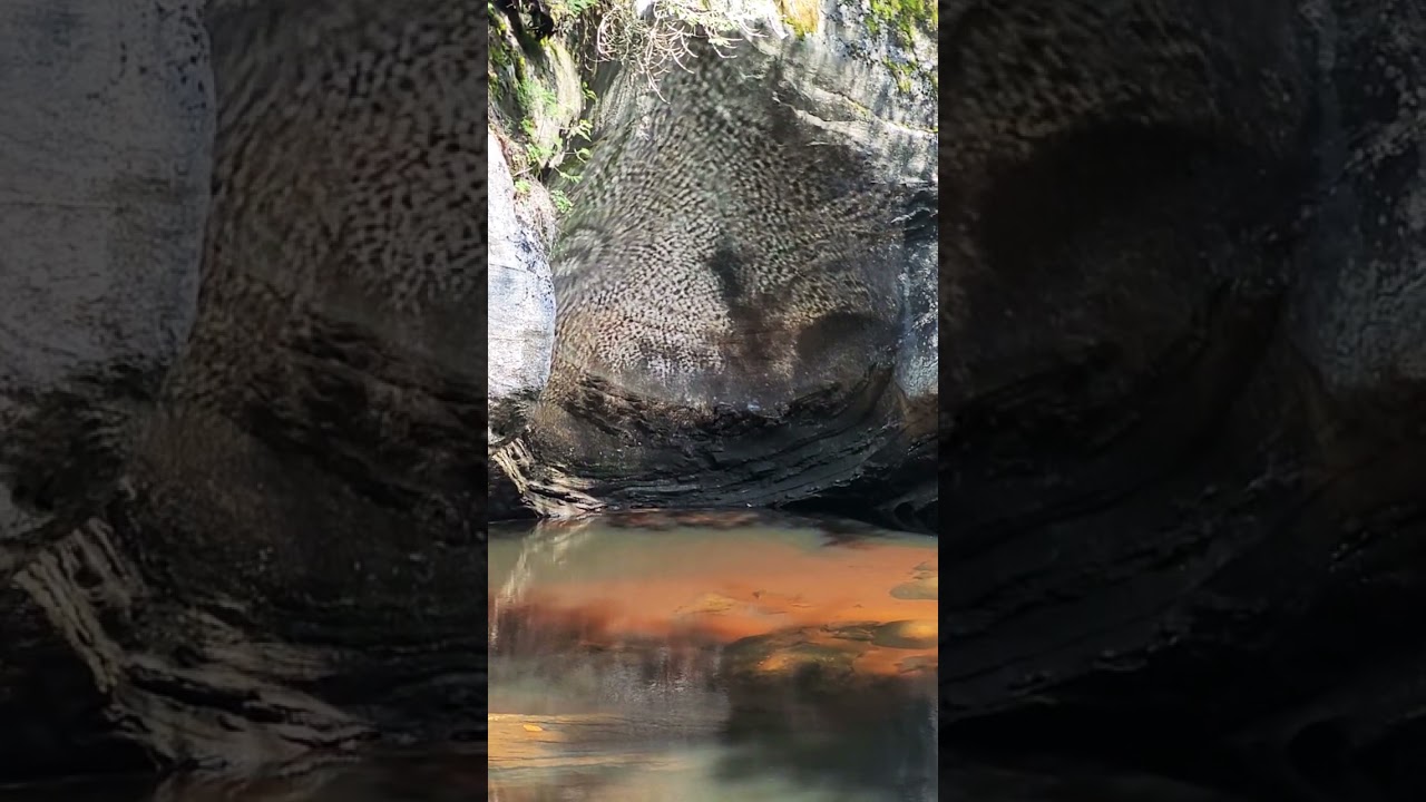 Mesmerizing water reflection on rock cave.