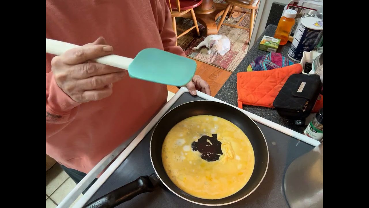 Making nice fluffy scrambled eggs. 