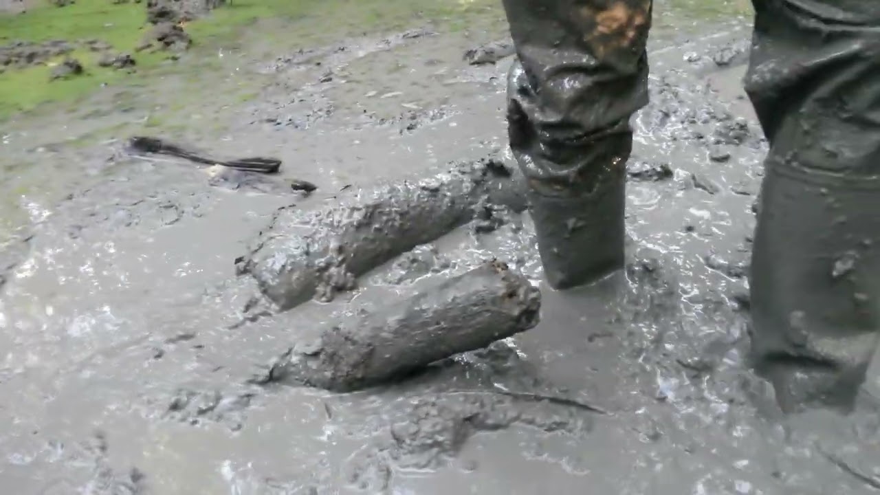 220704194 green Hunters and rainwear playing in muddy pond (cam #1)