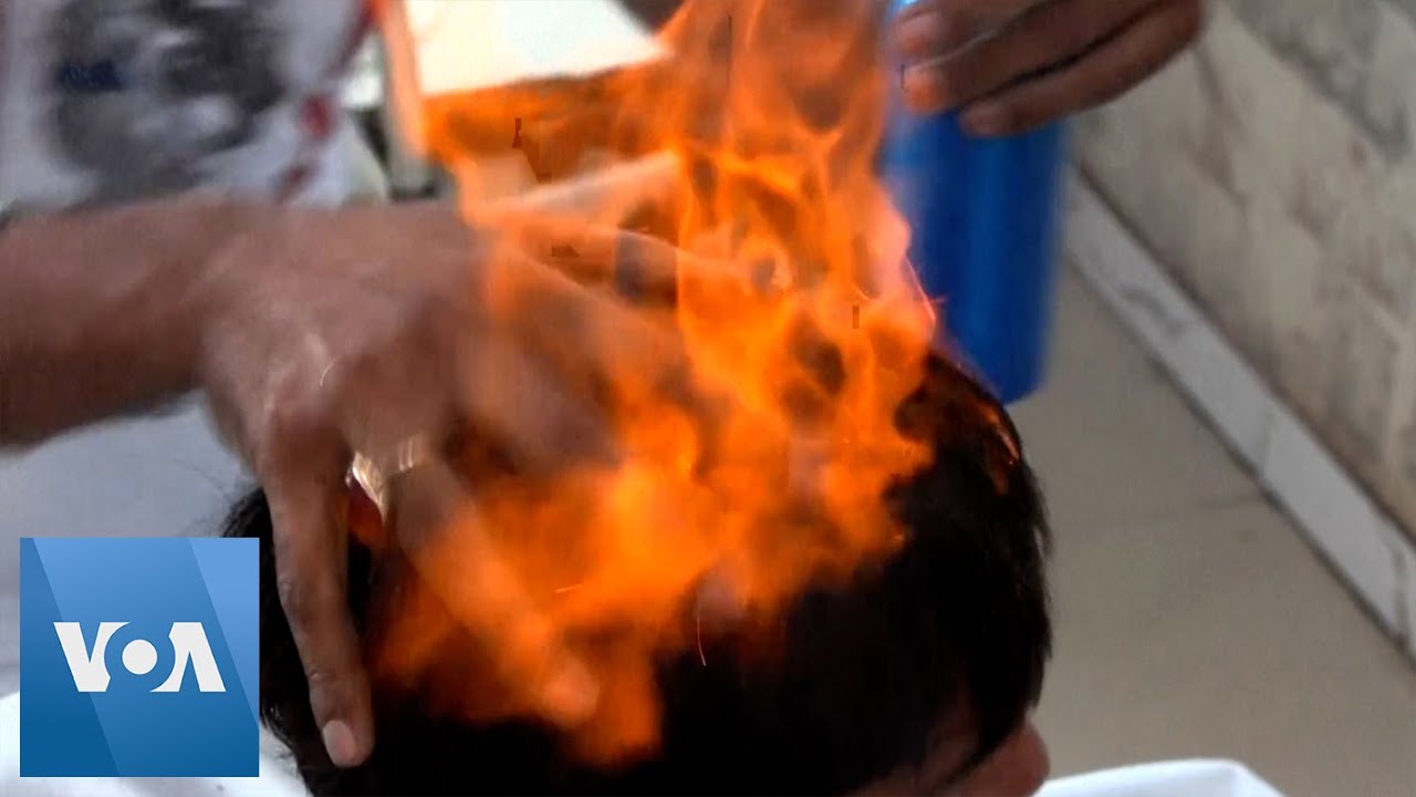 Pakistani Barber Offers Haircuts with Blowtorches, Cleavers