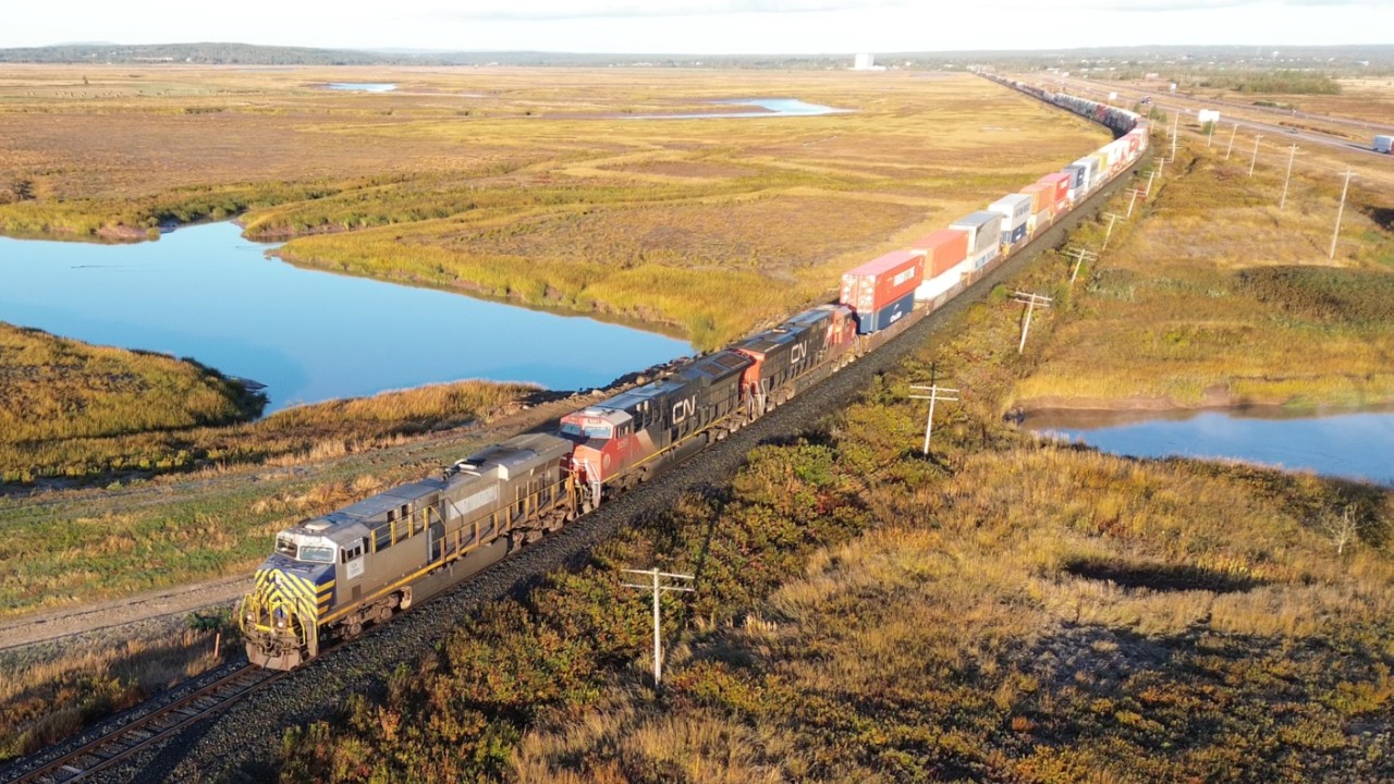 Awesome Aerial 4K View! Long Stack Train CN 120 w/DPU passing near Aulac, NB in Golden Hour Light