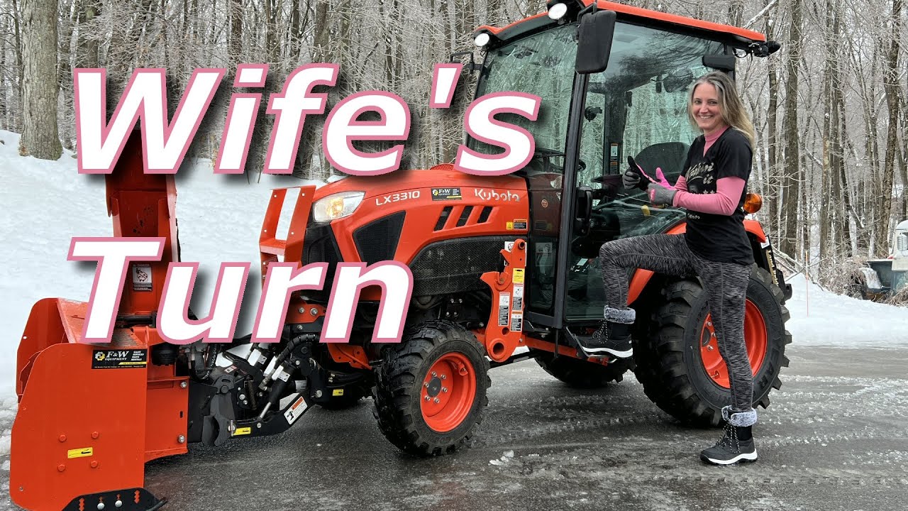 My wife using our Kubota LX3310 to clear our driveway with the LX2963 Snow Blower.