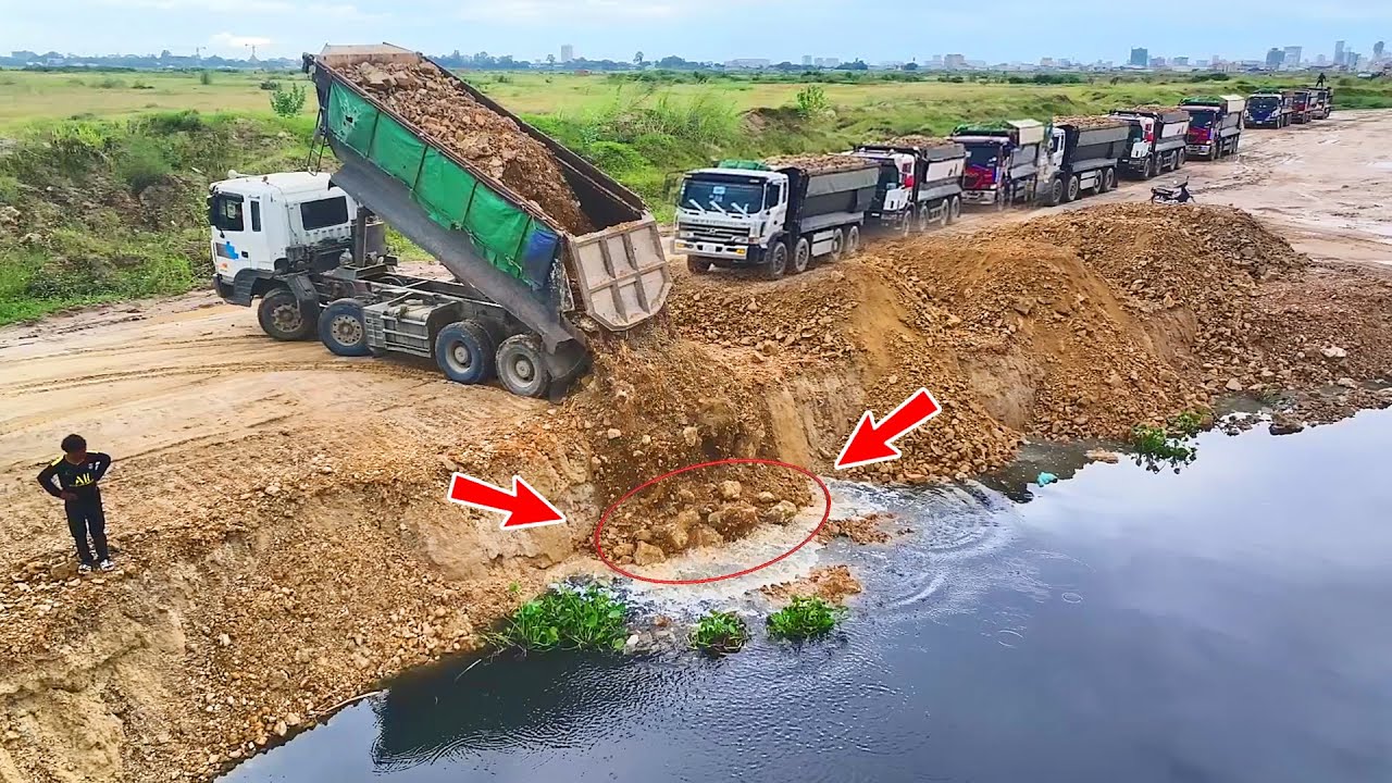 Process first Excellent Skill Dumping Soil Into Deep Water By Dump Trucks And Dozer D53p pushing
