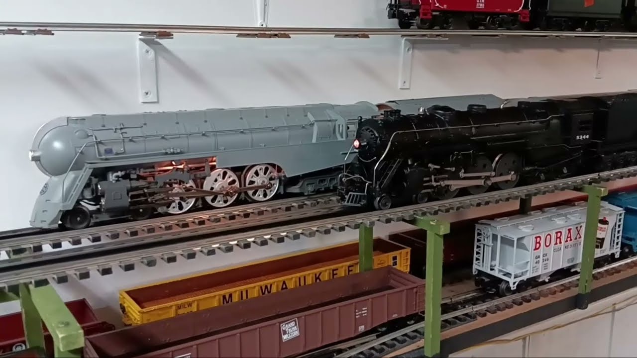 2 hudsons, pulling 2 passenger trains.