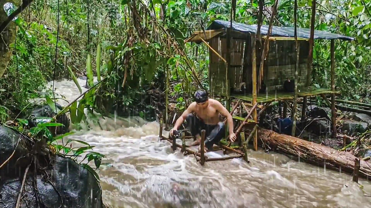 building a bamboo house on the riverbank during heavy rain and flooding