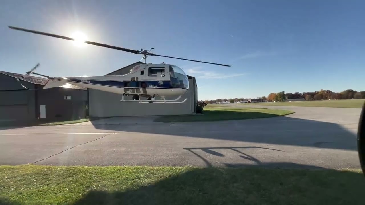 Bell 47 J moving in & out of hangar