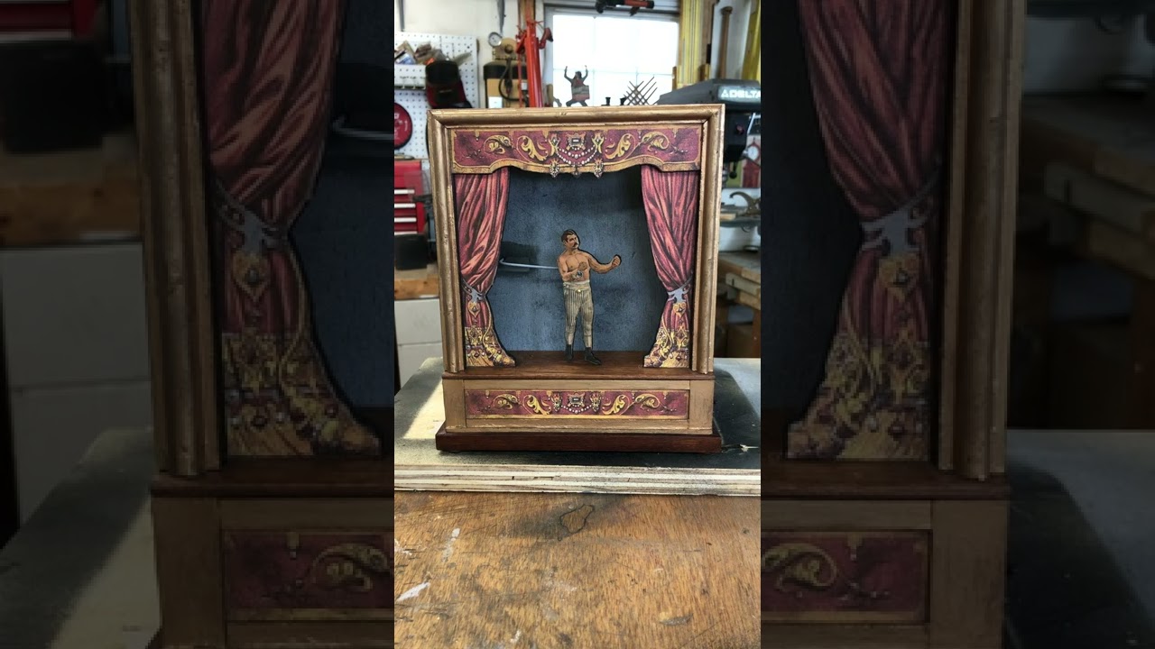 Changing the scenery, curtains, and character in Dan Strout's sand-powered automaton