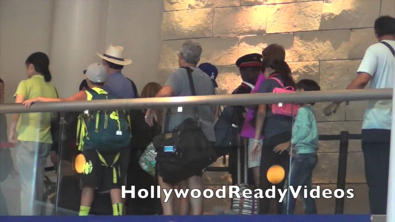 Dylan O'Brien shows love to fans arriving at LAX airport in LA for a departing flight to London