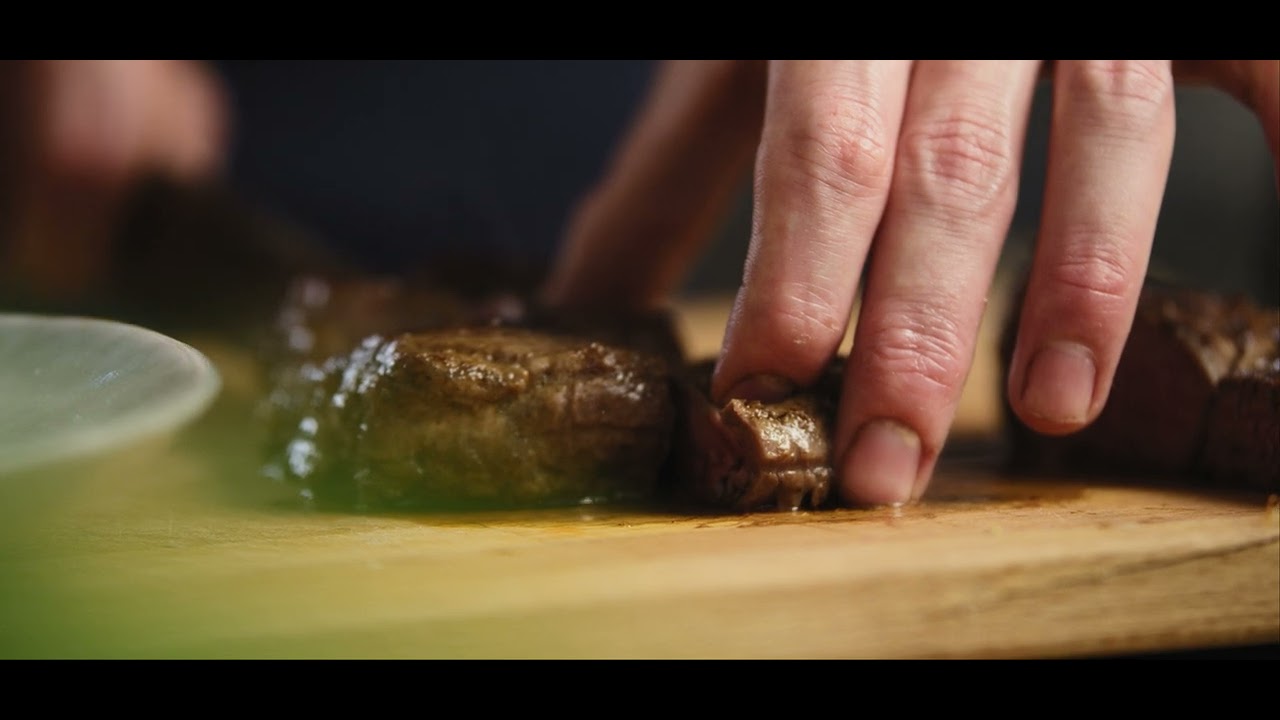 GOURMET CHEF CAREFULLY CUTTING A PIECE OF MEAT 4K