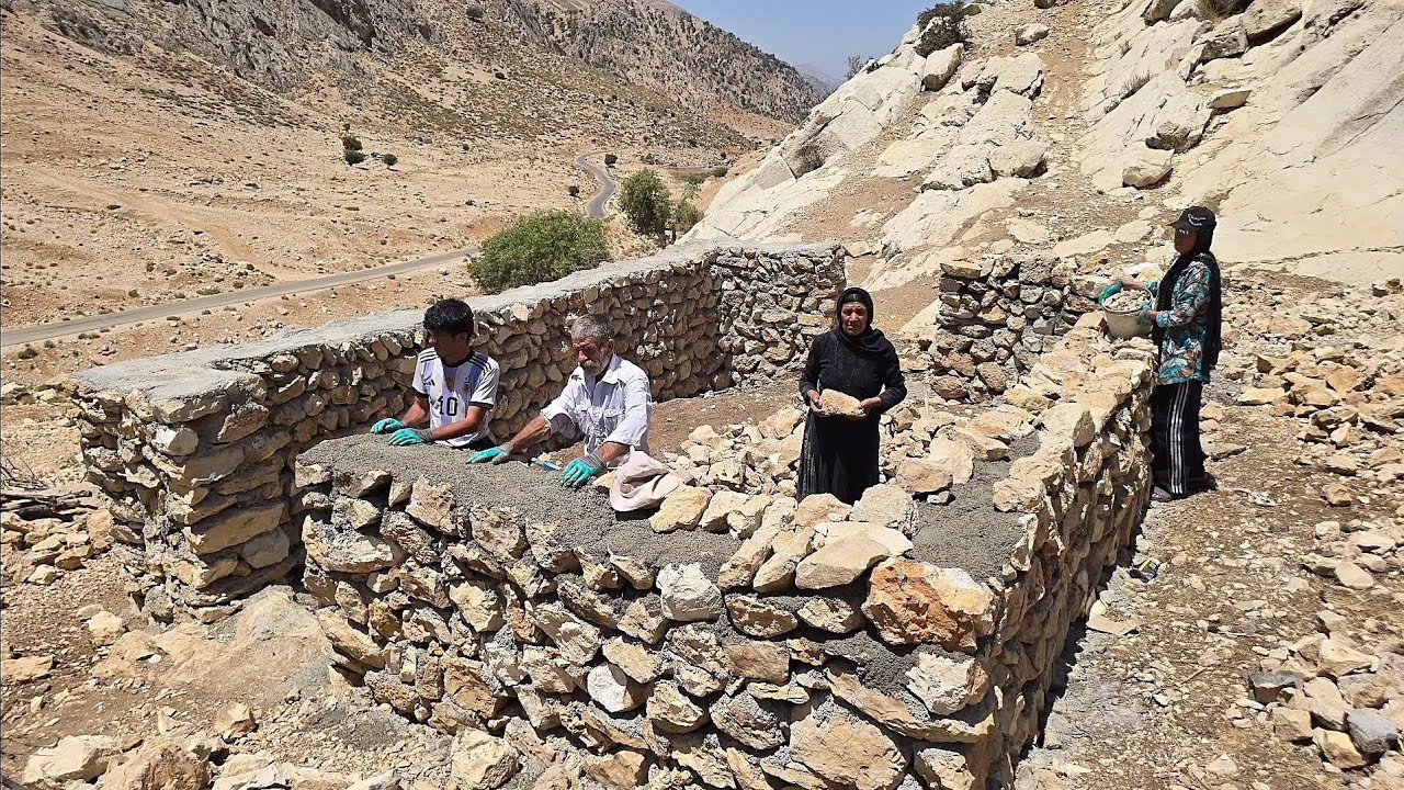 lran nomadic life: Building a stone pen for sheep with the efforts of a nomadic family