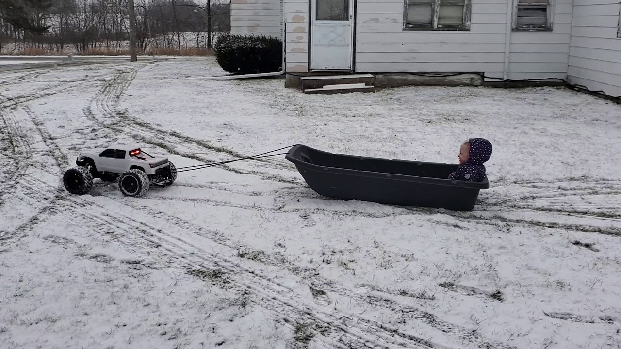 Traxxas xmaxx pulling kid in sled