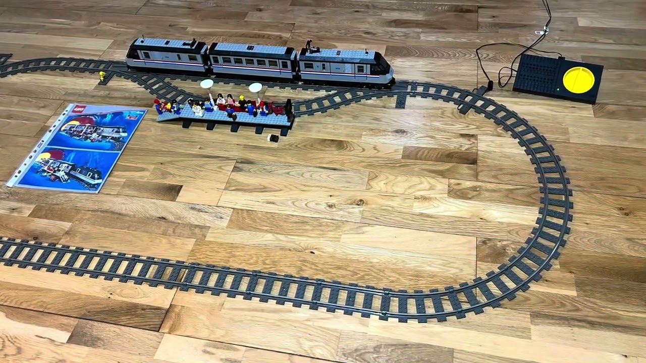 Lego Metroliner 9V train set 4558, running around track, with a crowded train station