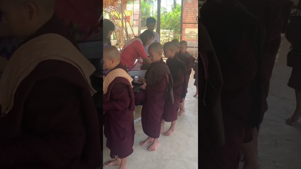 Offering food to monks for lunch.