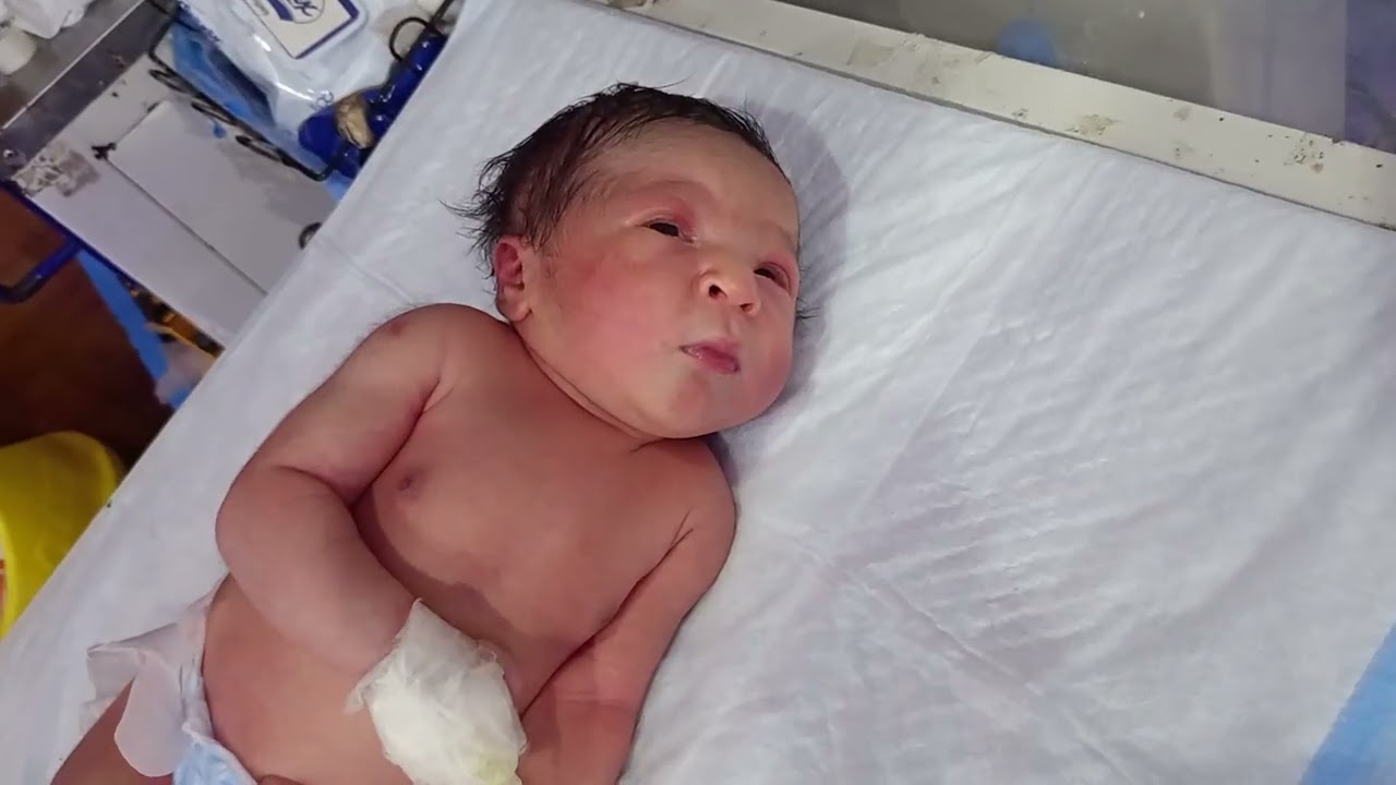 Bottle feeding to a thick baby boy.