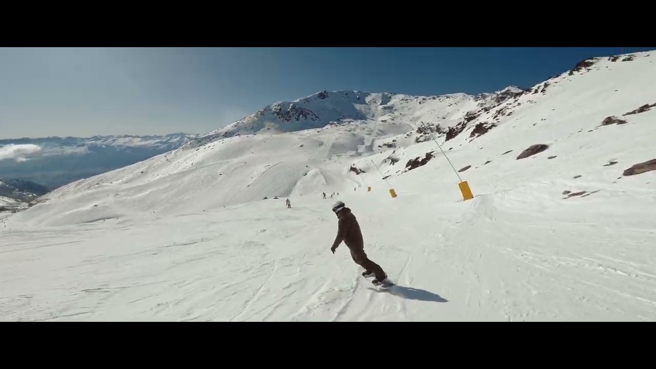 The Remarkables ski area - snowboarding downhill at sunny winter day - Queenstown, New Zealand.