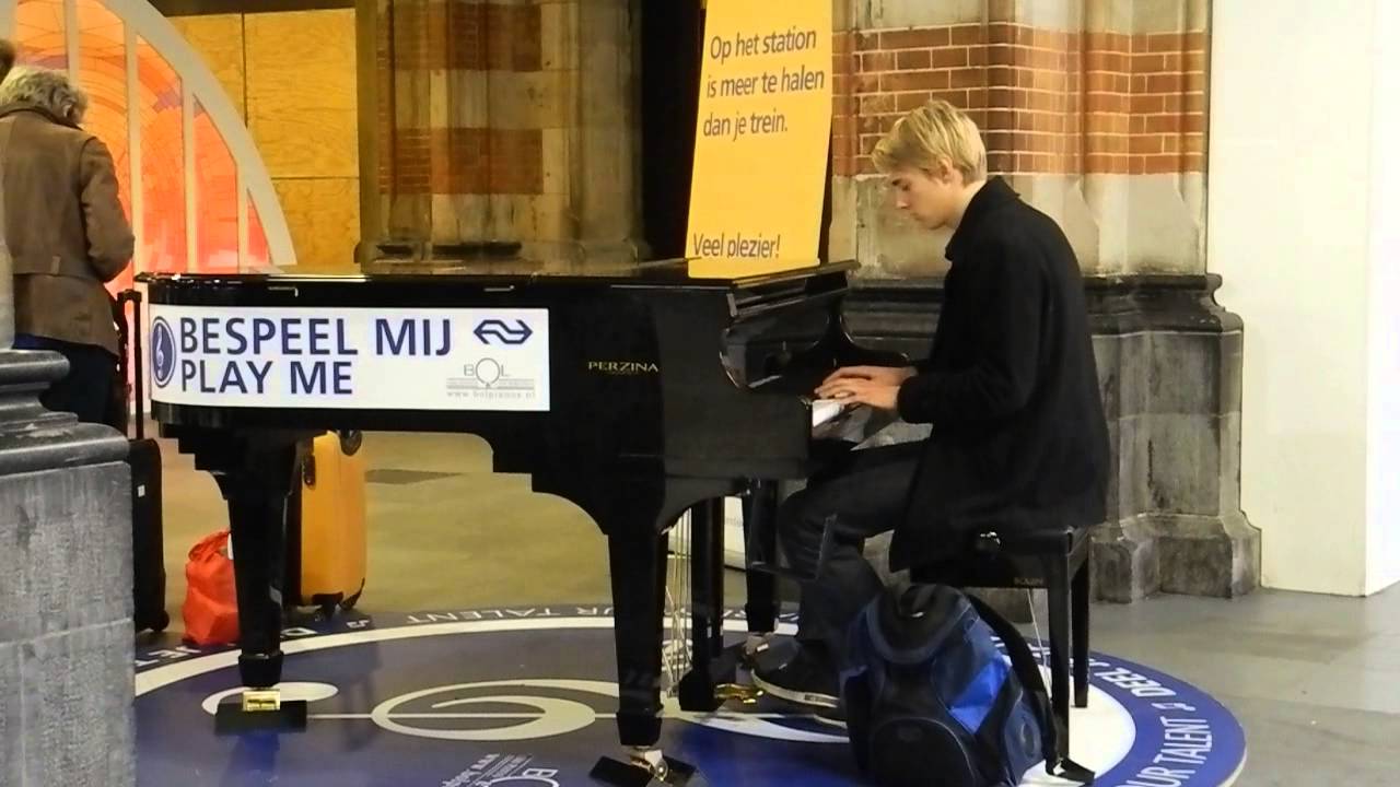A guy is playing piano so beautifully at Amsterdam railway station