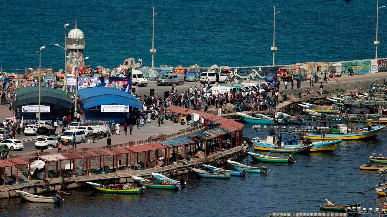 People gather at the Gaza port to see a cruise set off