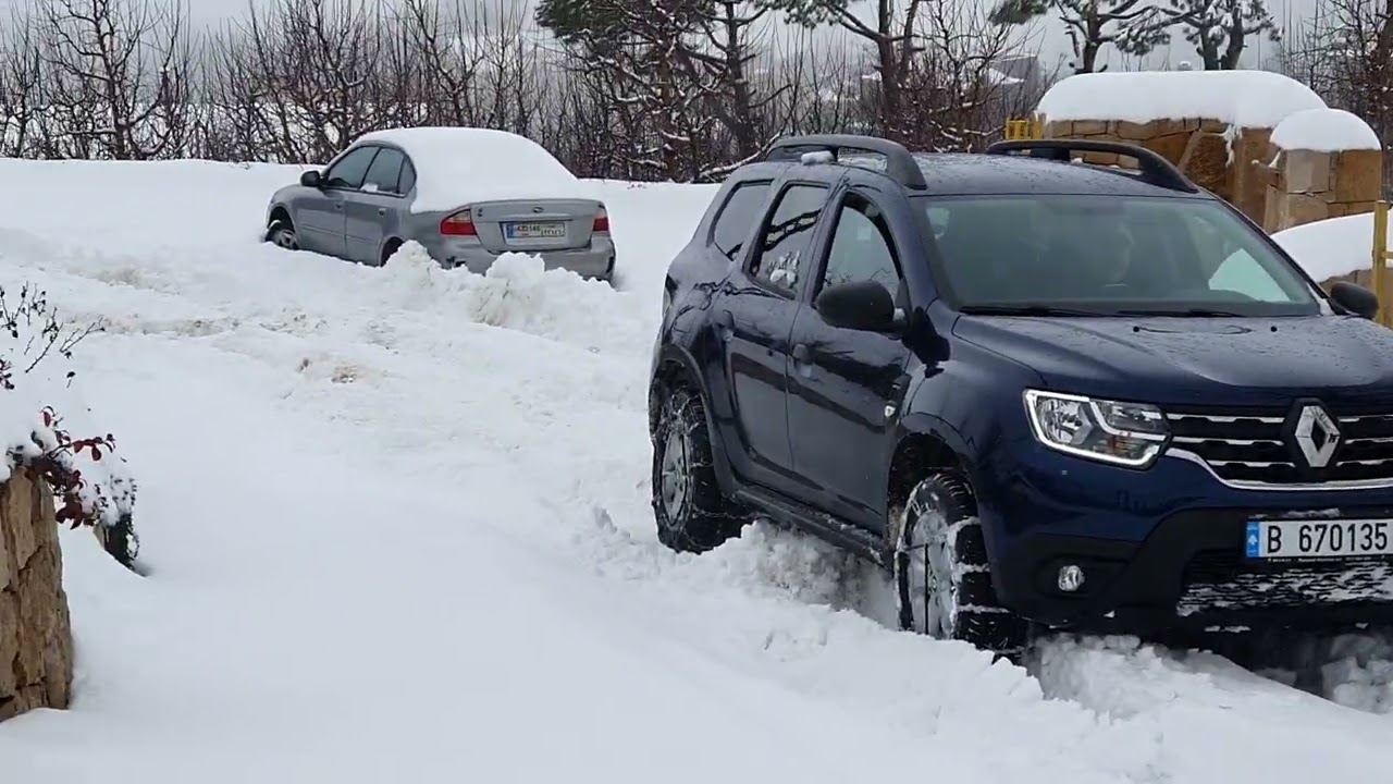 Renault Duster in deep snow with snow chains