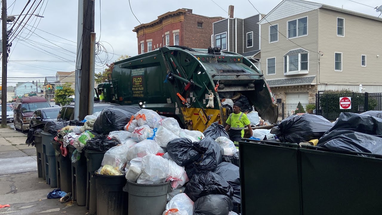 Garbage Truck Crushing a Massive Pile of Trash