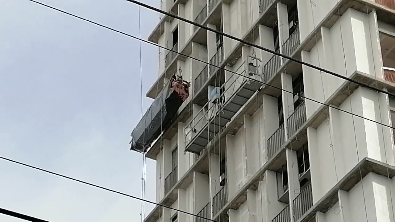 Repello/enjarrado exterior de Torre Chapultepec 67, trabajadores en canastillas