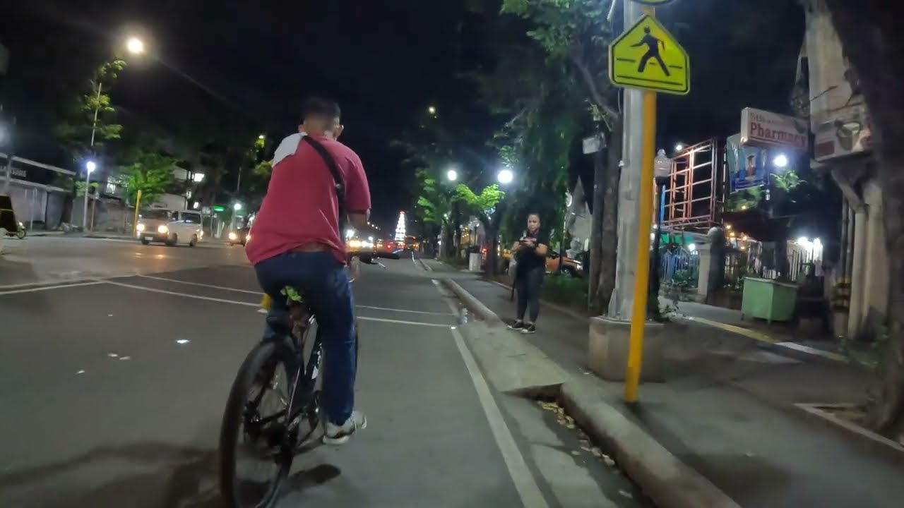 Bicycle tour from Fuente Osmena to Colon Street, Cebu City, Philippines, at night.