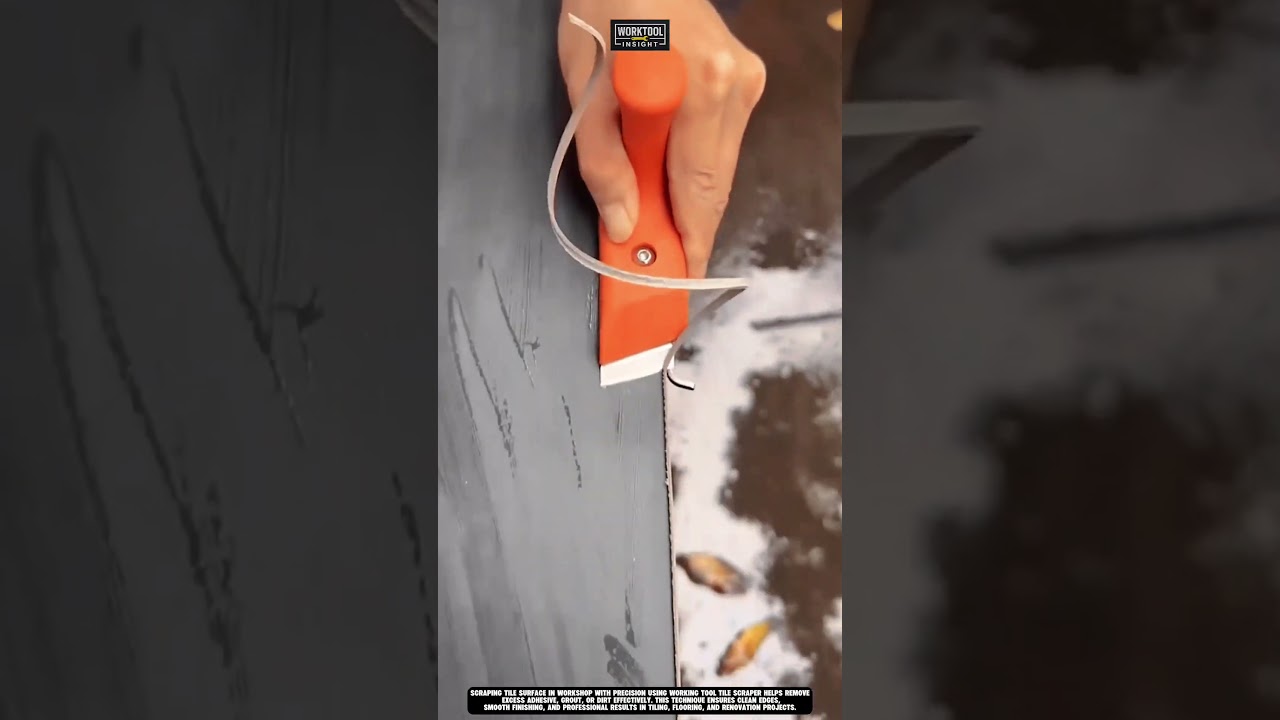 Scraping tile surface in workshop with precision using working tool tile scraper