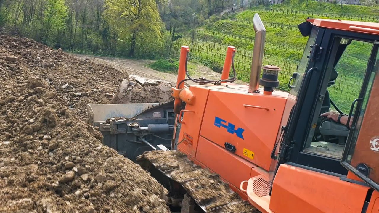 FIAT KOBELCO D150 pushing dirt on a wineyard - Scriò, Italy